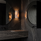 Fluted Stone Look Wall Sconce in a dark bathroom