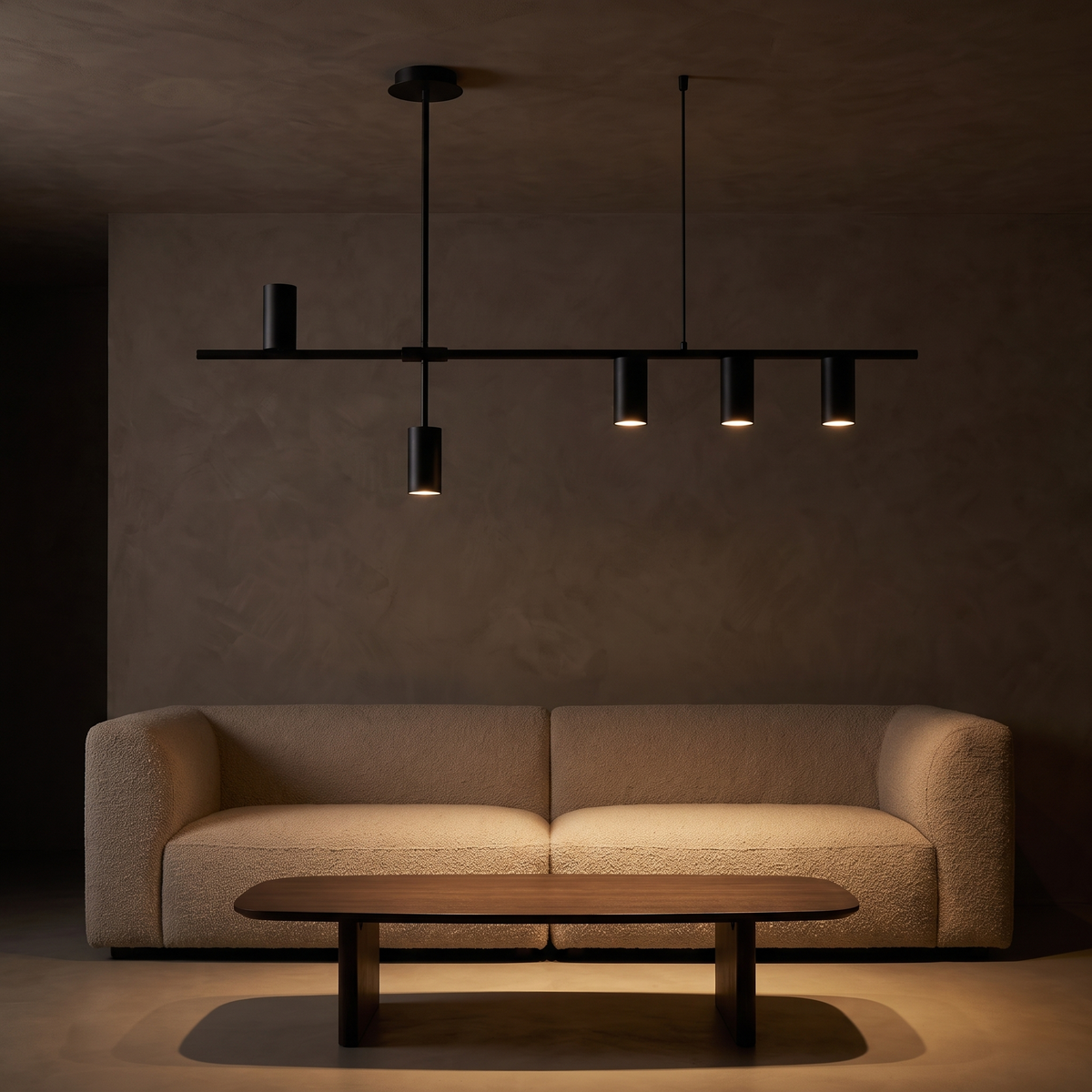 Modern Linear Spotlight Pendant Light above a sofa and coffee table in a dark living room