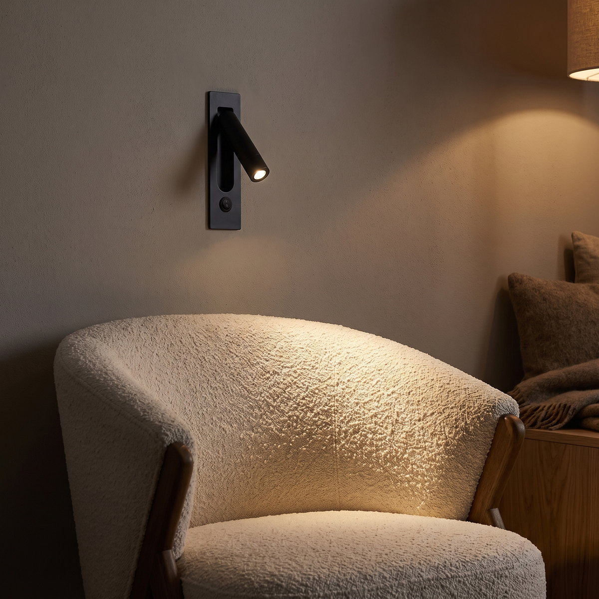 Modern Recessed Bedside Reading Light above a boucle reading armchair