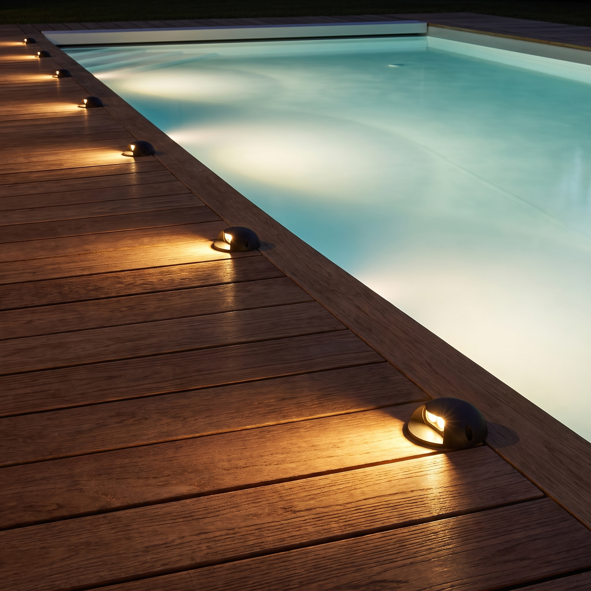 Modern LED Deck and Step Lights along a timber pool deck at night