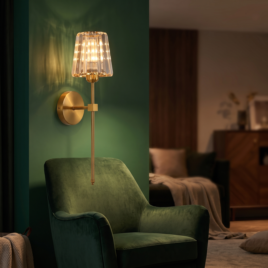Modern Crystal Cordless Wall Sconce above a green velvet armchair