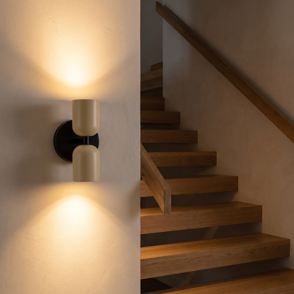 Modern Black and Ivory Up Down Sconce beside an oak staircase