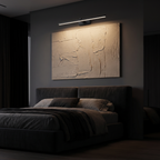 Modern LED Picture Light Bar lighting a canvas above a bed headboard