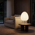 Japanese Rice Paper Egg Table Lamp on a side table beside a linen sofa