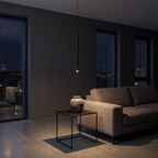 Modern Slim Tube Pendant Light hanging beside a sofa in a dark living room