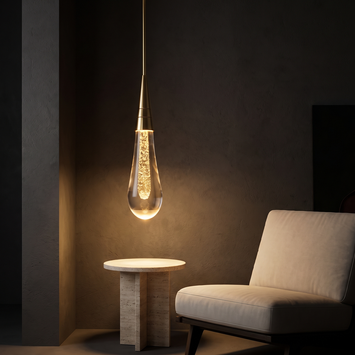 Modern Glass Teardrop Pendant Light over a travertine side table beside a lounge chair
