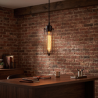Industrial Wire Cage Pendant Light over a walnut desk against a brick wall