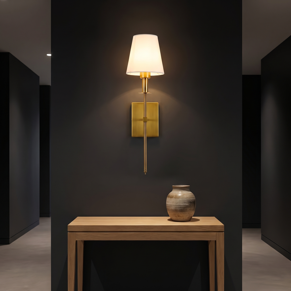 Modern Brass Wall Sconce with Shade above an oak console in a dark hallway
