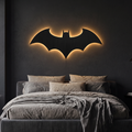 Halloween Bat Wall Lamp glowing above a bed in a dark bedroom