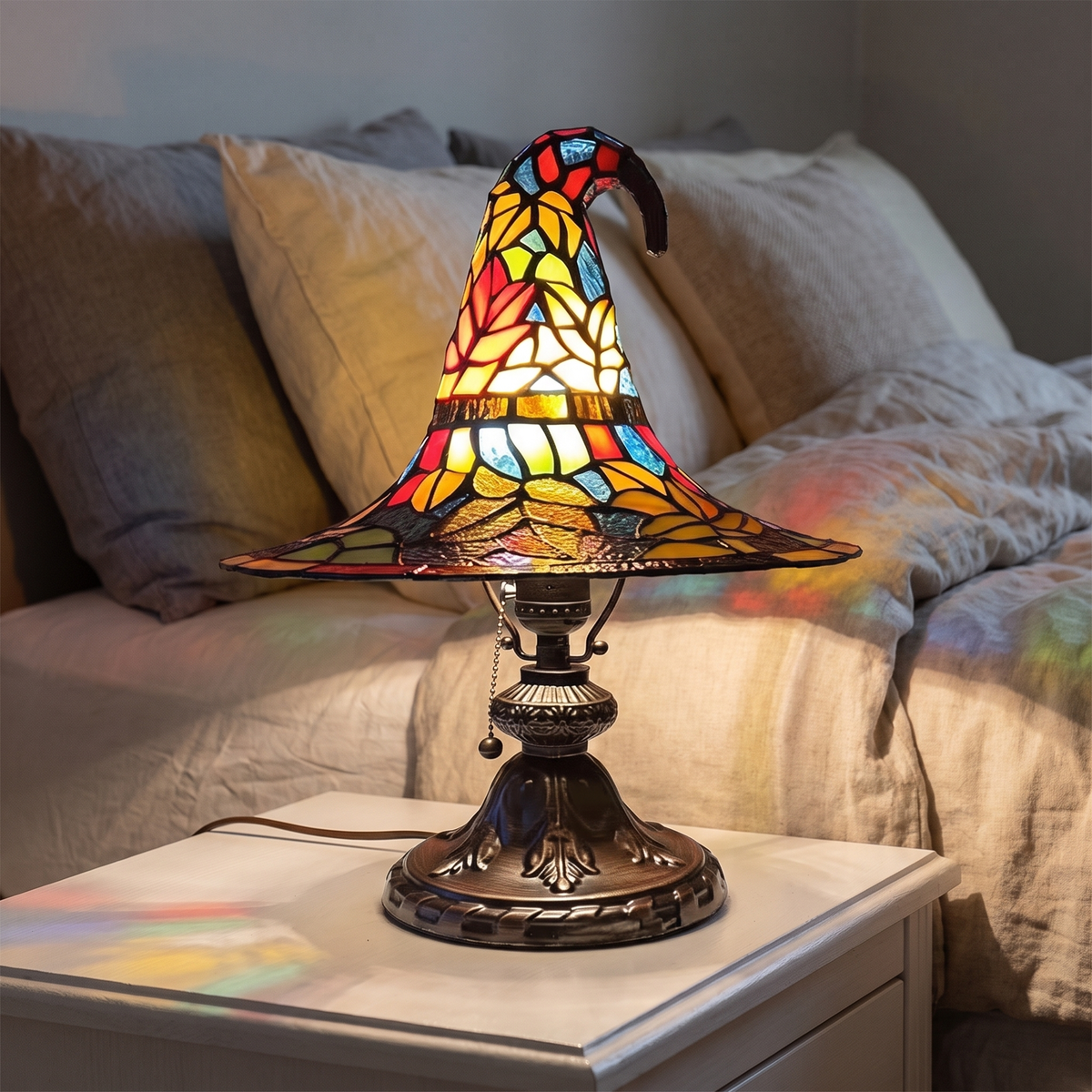 Stained Glass Witch Hat Lamp on a white nightstand at night