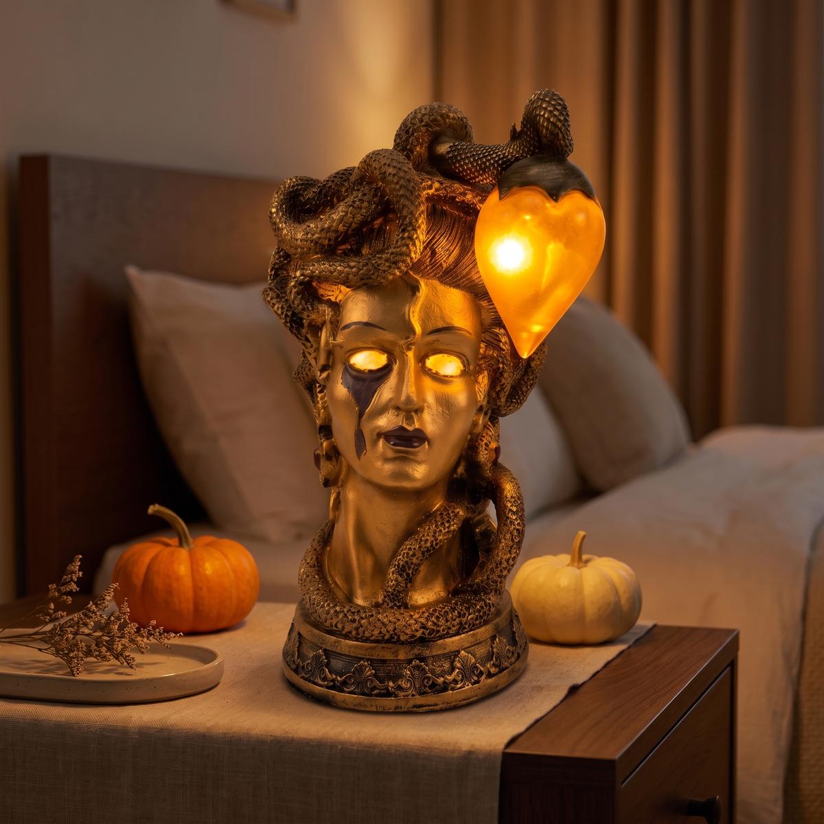 Medusa Table Lamp, Gold on a nightstand at night