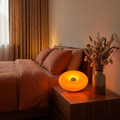 Donut Lamp in Orange on a bedroom nightstand
