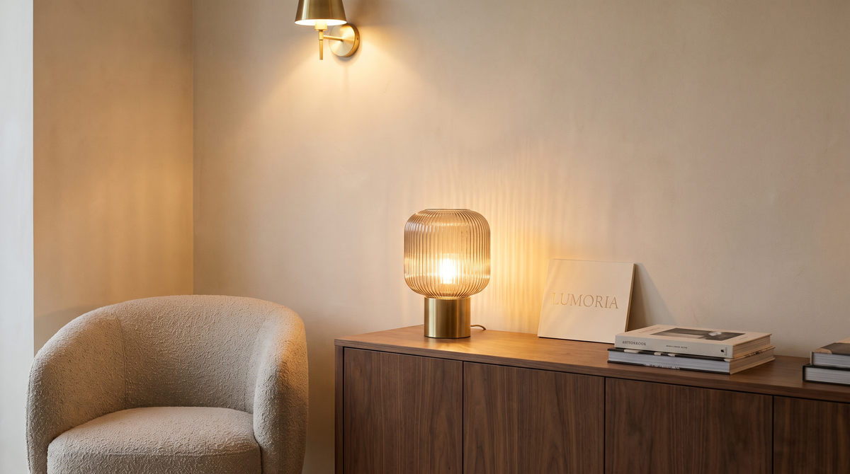 Lumoria ribbed glass table lamp and brass sconce in a living room