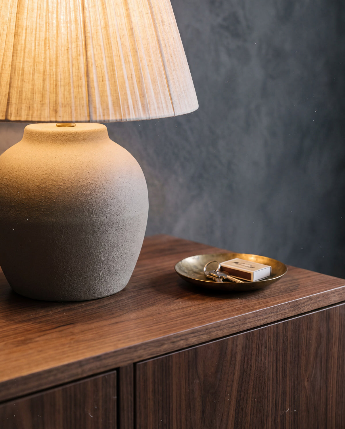 A ceramic table lamp with a linen shade