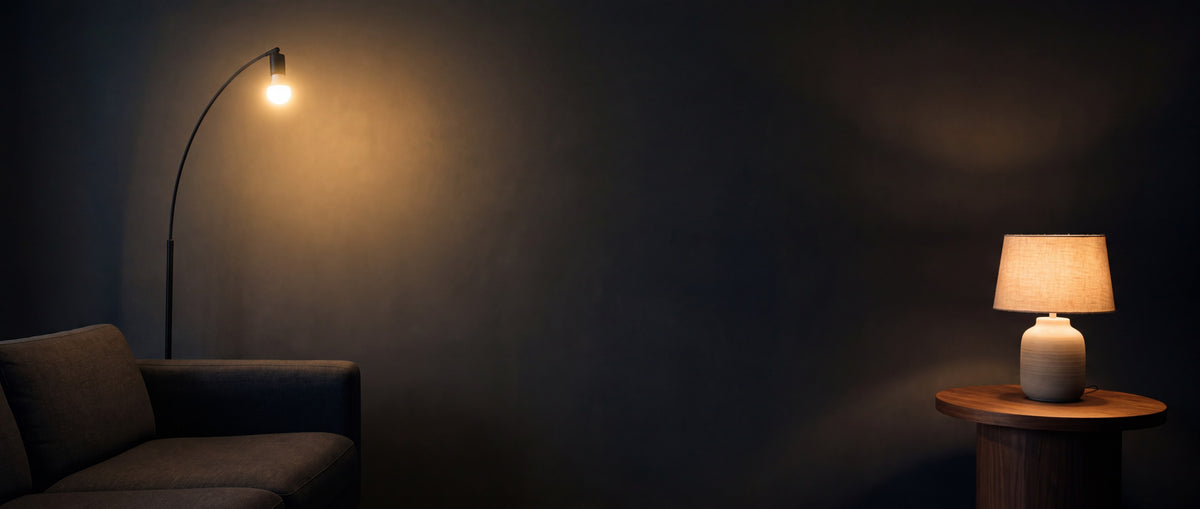 Arc floor lamp and table lamp glowing in a dark living room