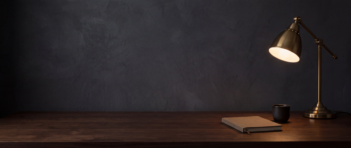 Brass desk lamp on a dark walnut desk